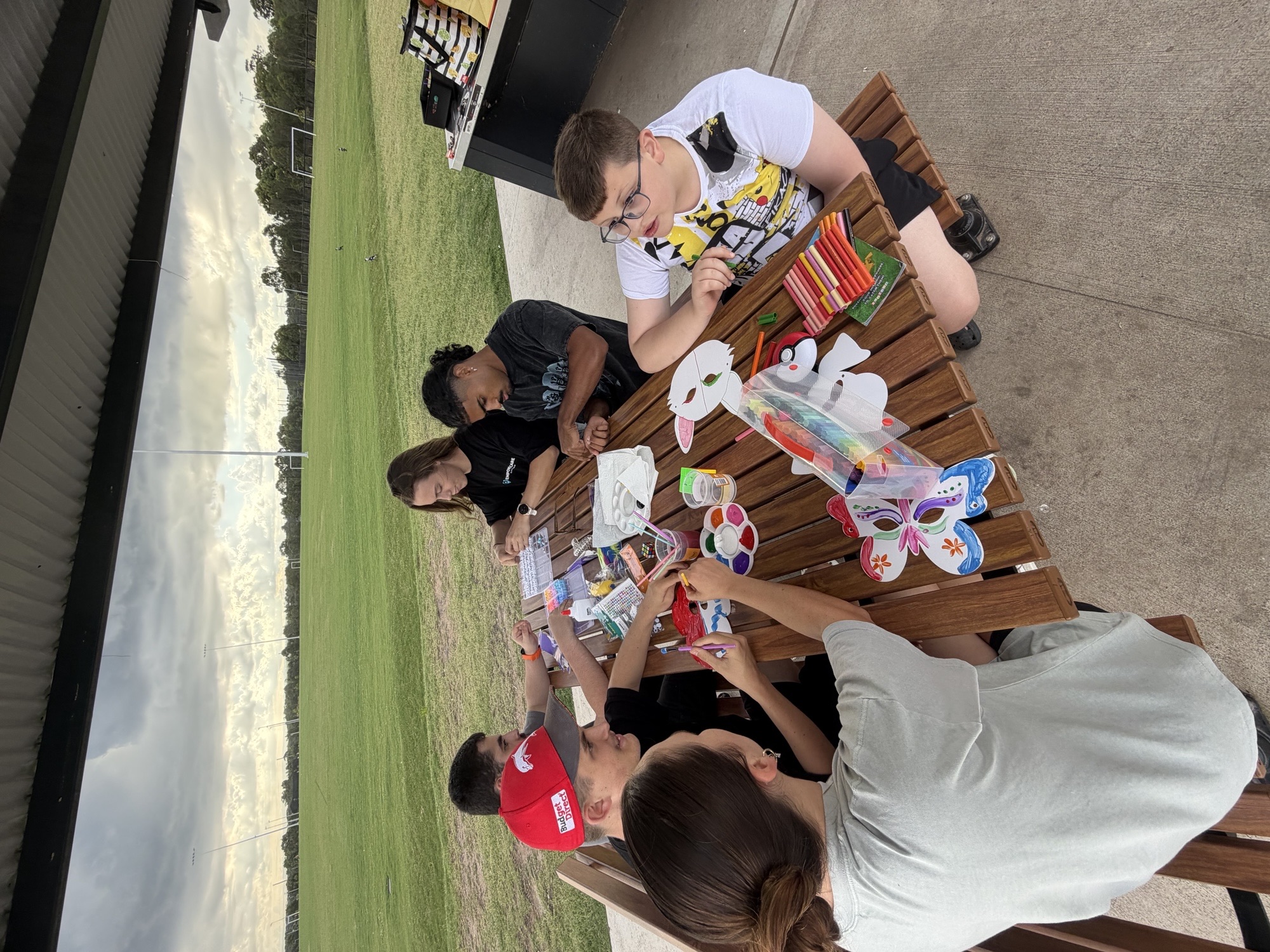 Kids and pre-teens doing arts and crafts together at a program session